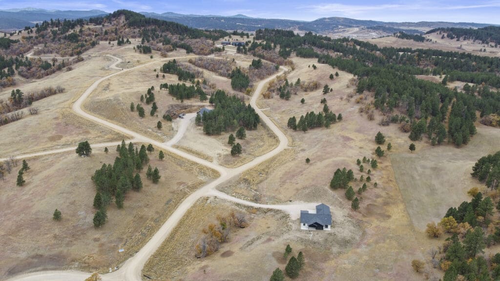 Custom home built by Legacy Custom Homes & Design in Whitewood, SD, featuring open acreage, rolling hills, and scenic Black Hills landscape.