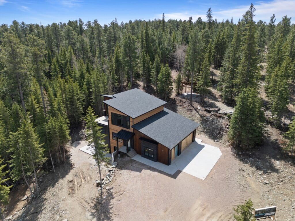 A custom home for sale with wood, rustic exterior being built by Legacy Custom Homes & Design. The home is located at 11286 Eastwind Court in Lead, SD, 57754.