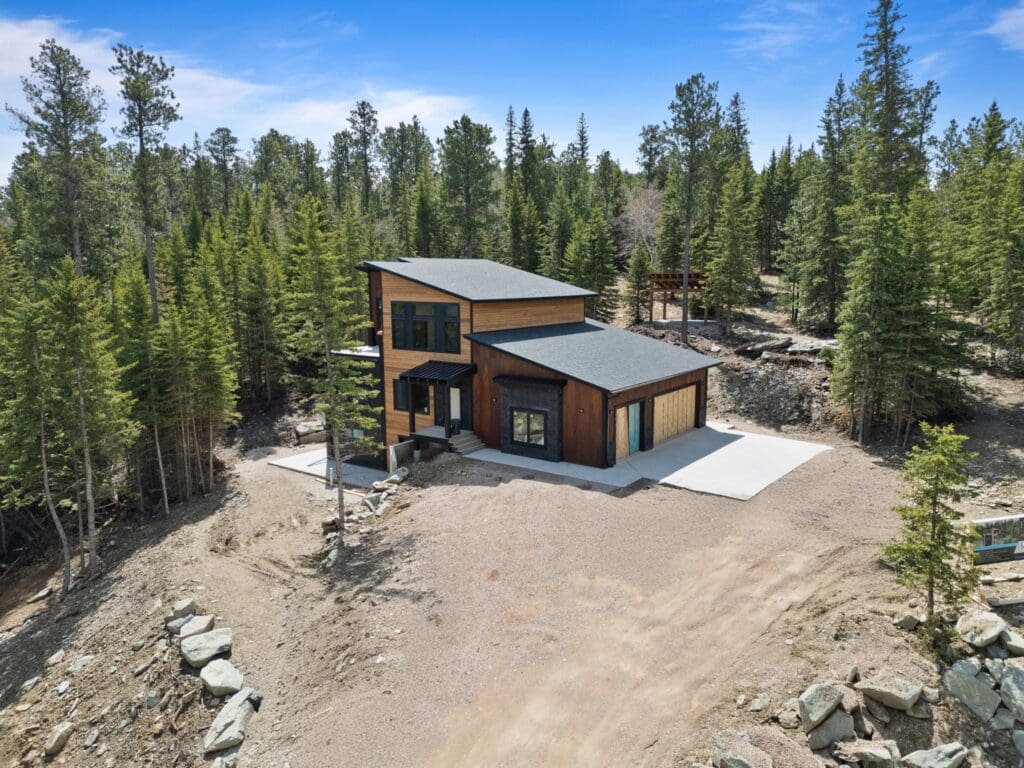 A custom home with three levels, including a two car garage, unique roofline and second level deck. The home is being built by Legacy Custom Homes & Design in the Powder House Pass Subdivision in Lead, SD at 11286 Eastwind Court.
